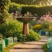 Copper bird bath and bee hotel in a lush garden with flowering plants and recycled-glass pathway markers, photographed in warm golden hour light.