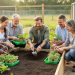 “An outdoor community garden workshop where an instructor demonstrates soil preparation beside raised beds while participants hold gardening tools and seedlings.”