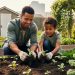 “Neighbors kneeling together in a community garden, planting seedlings in raised beds with vibrant green plants and flowers.”